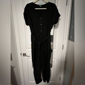 Black jumpsuit. Buttons down the front with a tie.